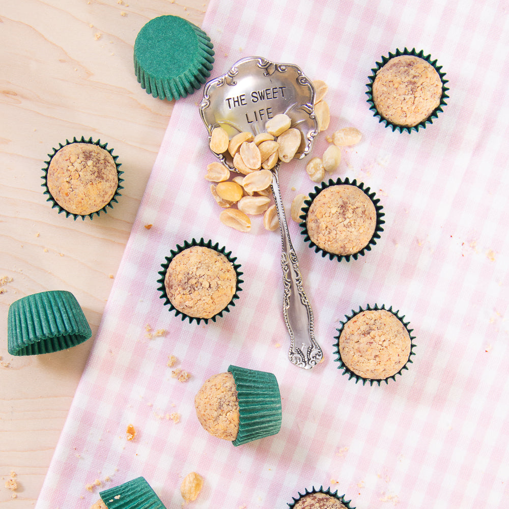 Peanut butter and chocolate Brigadeiros with peanuts on spoon